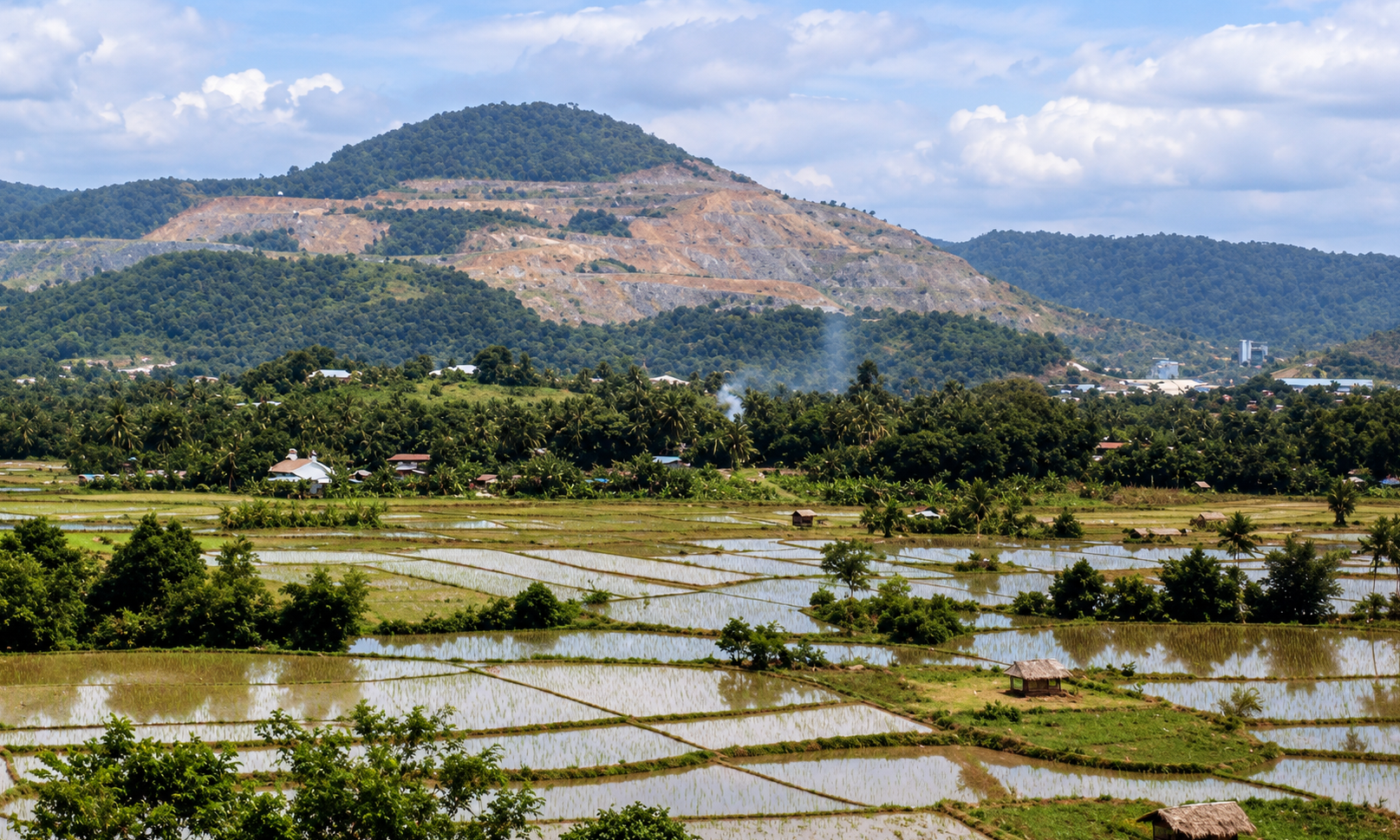 Flooded rice fields beneath the terraced slopes of Mount Tapian.
