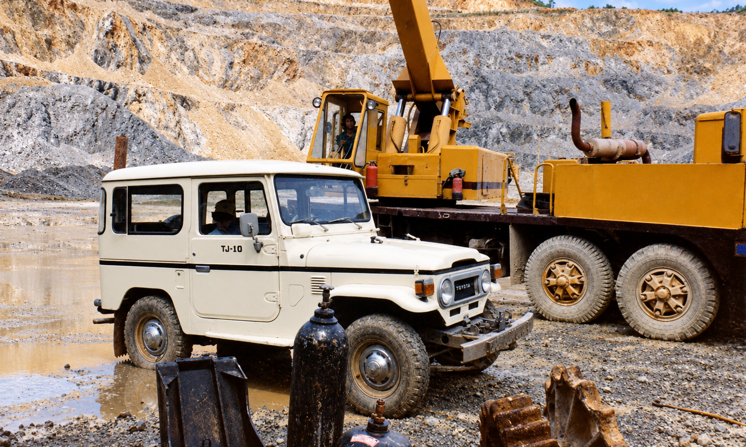 A white Toyota Land Cruiser parked beside a yellow crane at the mine.