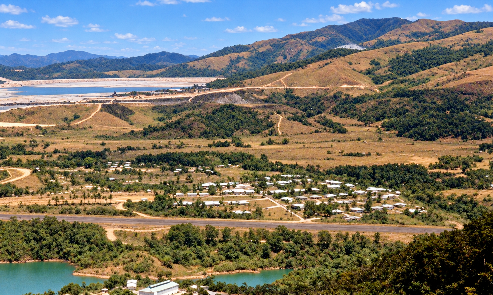 A view across the townsite and airstrip toward the tailings dam and surrounding hills.