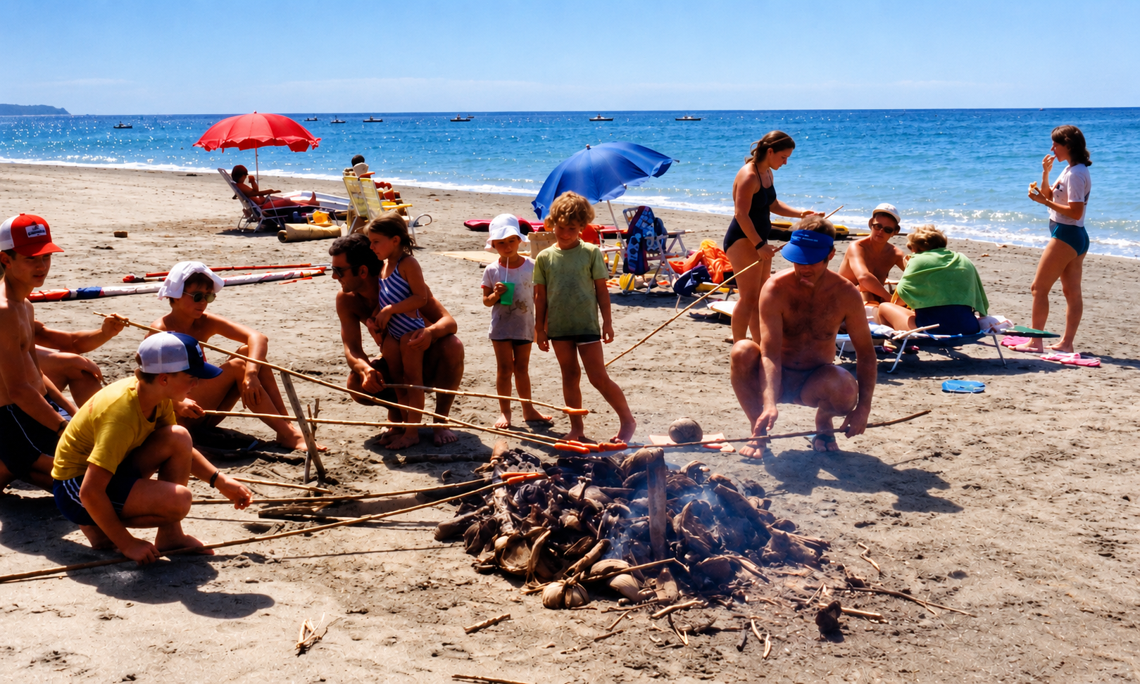 Adults and children roasting hot dogs over a fire on the beach, with umbrellas, lounge chairs, and the sea behind them.