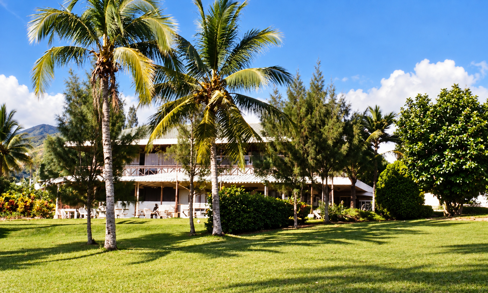 The Marcopper clubhouse surrounded by palm trees and lawn.