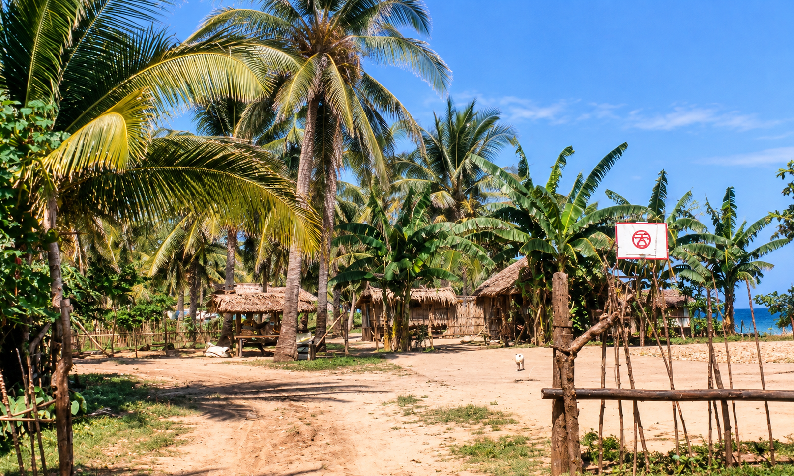 A beach settlement with bamboo huts, coconut palms, and a basketball hoop.