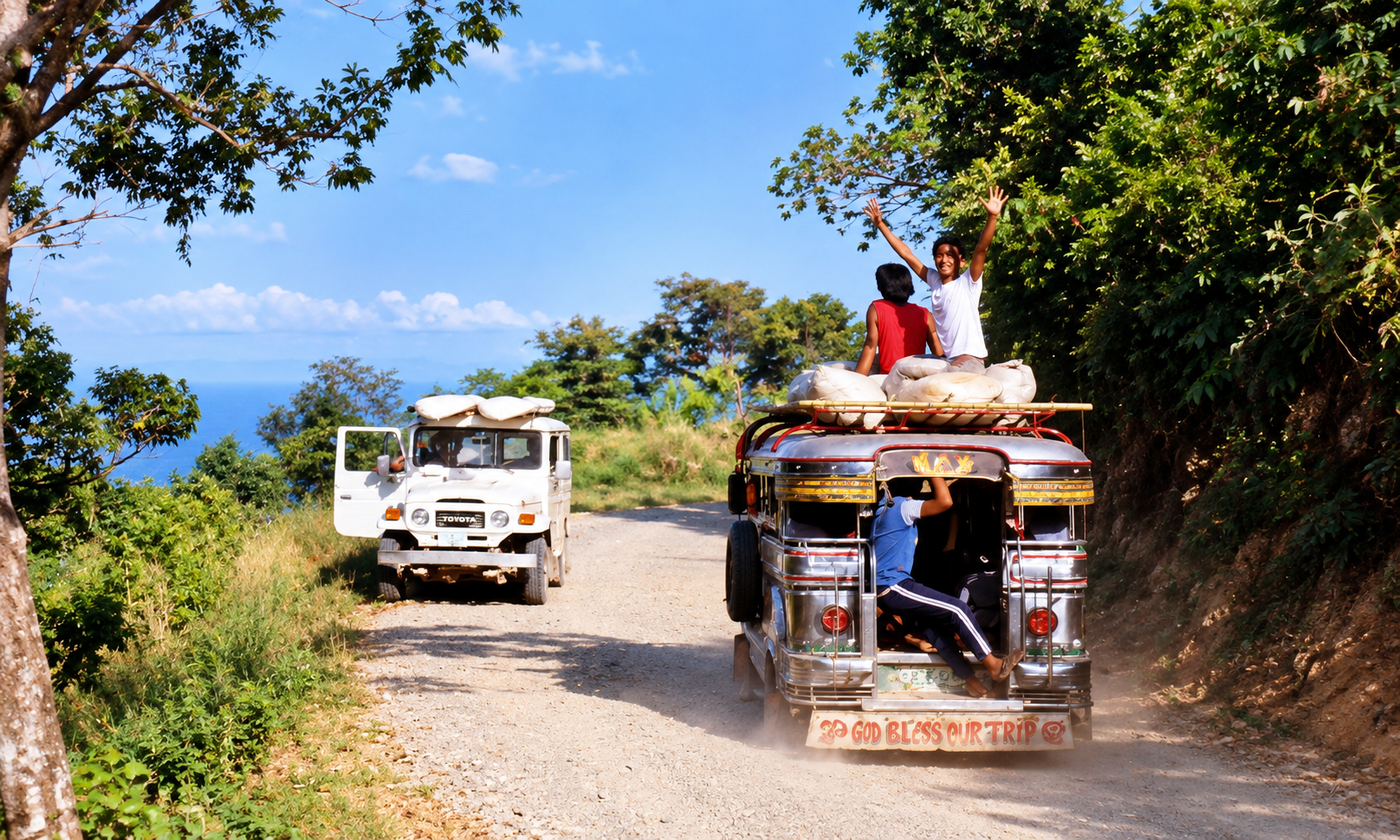 A loaded jeepney with a waving passenger on its roof beside a white Toyota.