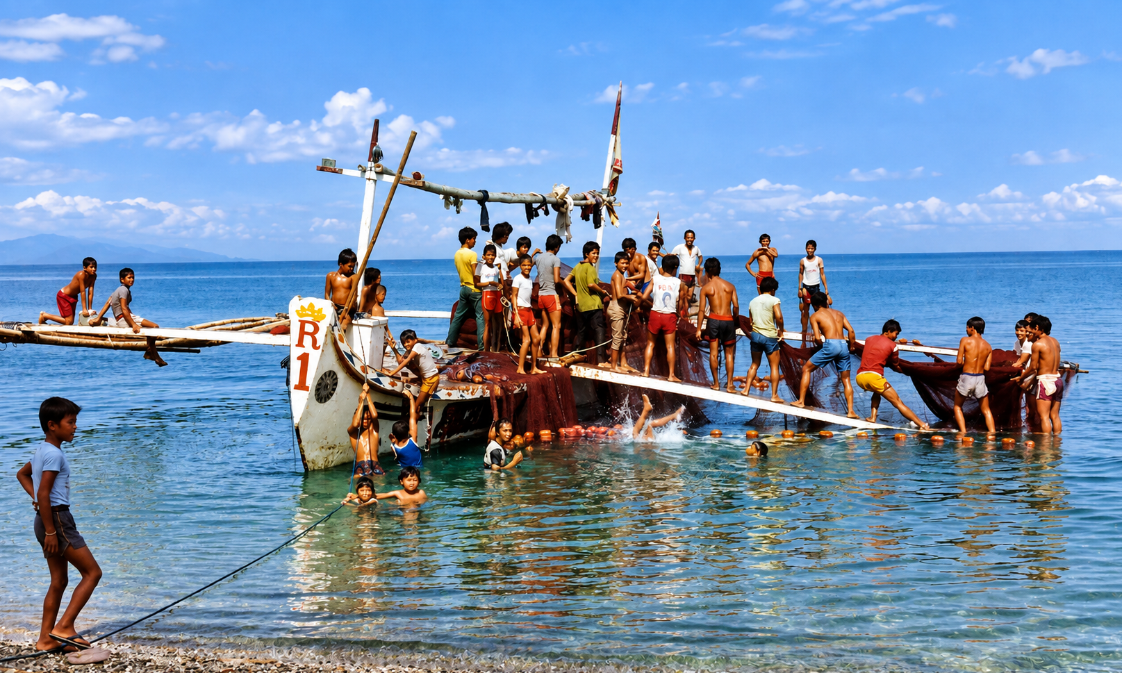 Boys gathered on a large outrigger boat and swimming in the water around it.
