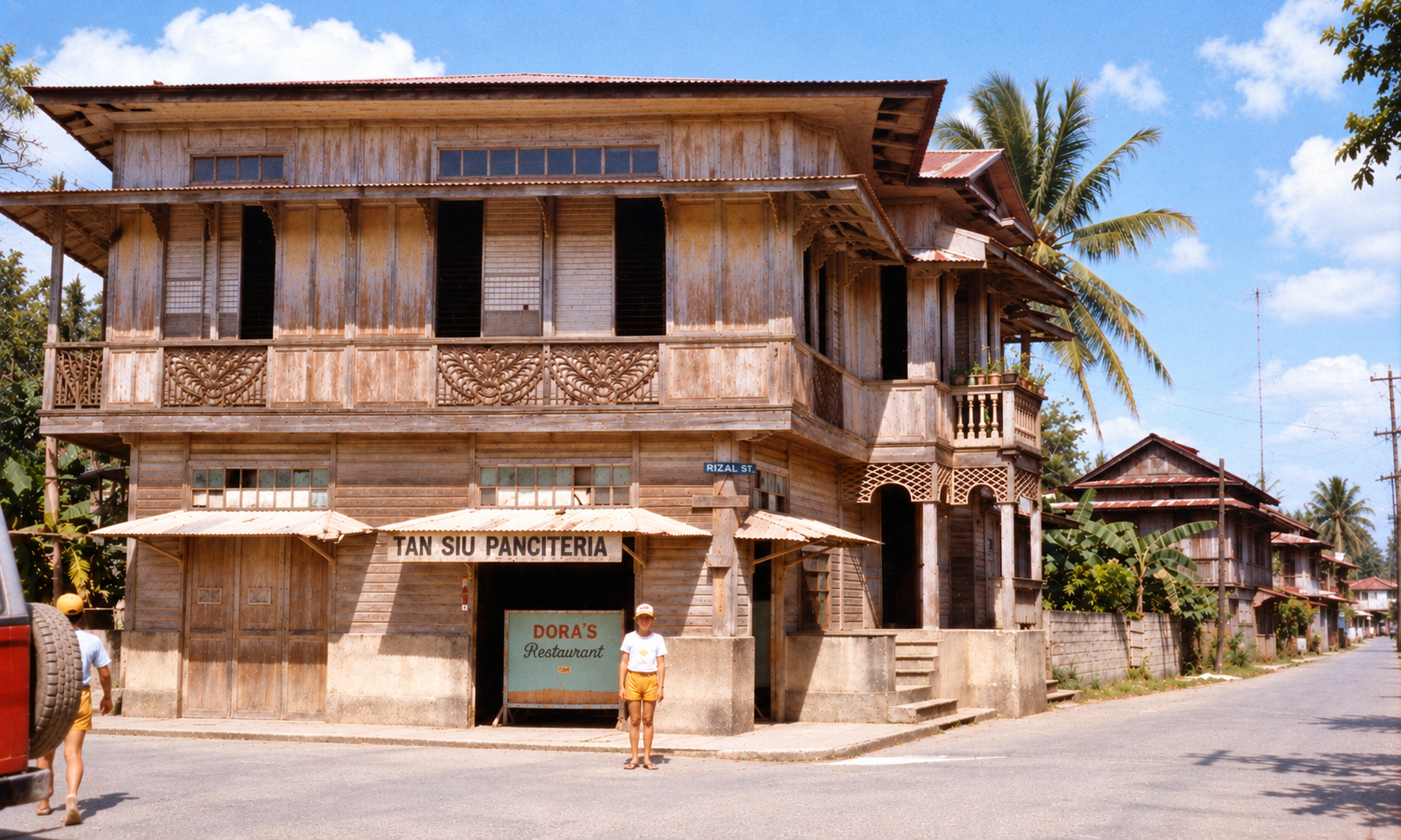 A child outside a wooden building with signs for Tan Siu Panciteria and Dora’s Restaurant.