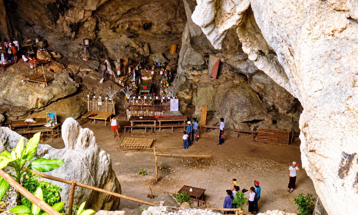 Visitors gathered near religious shrines inside the rocky interior of Bathala Caves.